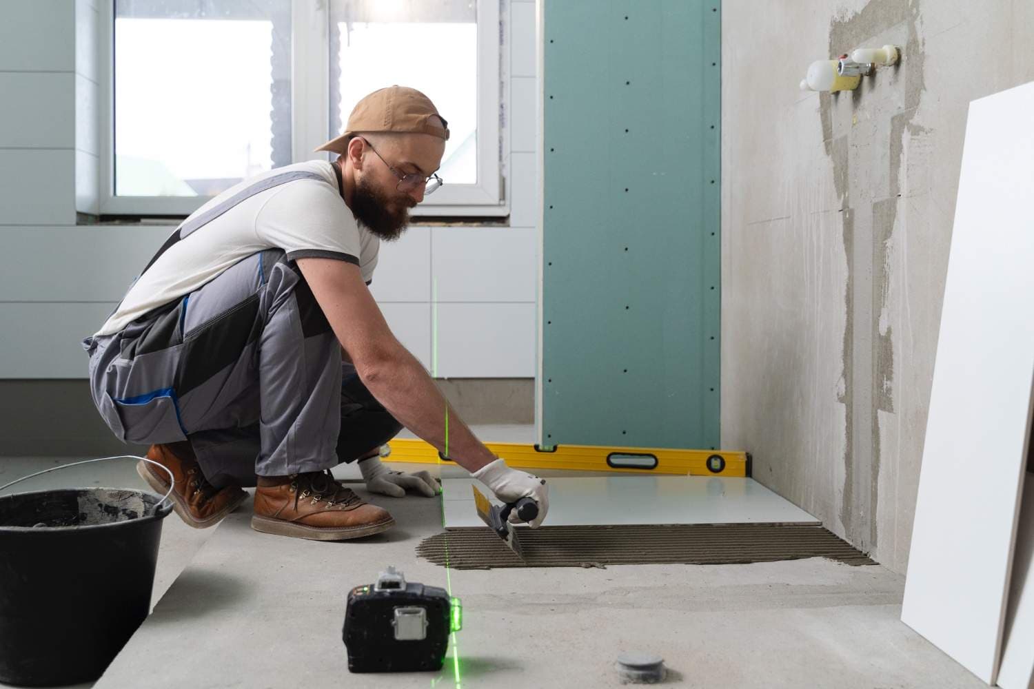 Waterproofing membrane being applied to bathroom walls and floor before tiling in a Melbourne renovation