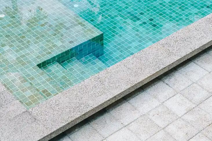 Non-Slip Pool Surround Tiles Textured tiles around a swimming pool designed for wet outdoor conditions
