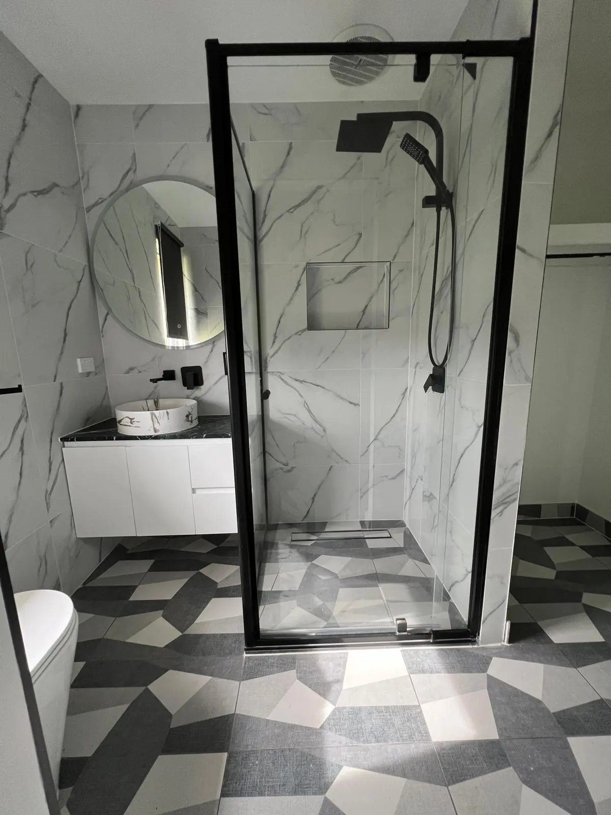 Swimming pool surround with white mosaic tiles and coping